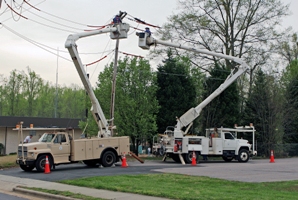 Two Power Trucks working on a power pole